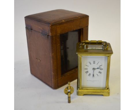 A brass carriage clock with enamel dial and bevelled glass panels, retailer Sir John Bennett Ltd., Paris, 12 cm high, to/w an