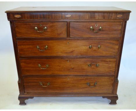 A George III mahogany chest of two short over three long graduated cockbeaded drawers flanked by reeded quarter columns, on s
