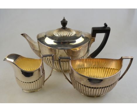 A Victorian heavy quality silver oval half-reeded three-piece tea service, the teapot with ebony finial and handle, W & J Bar
