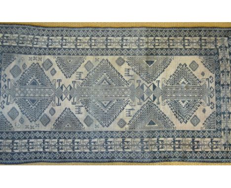Belouch runner with three medallions on a light brown ground within dark repeating border
