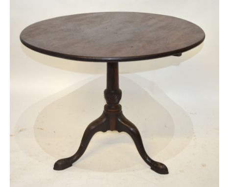 A George III mahogany tripod table, the circular tilt top raised on a turned pillar having a moulded collar to swept legs ter