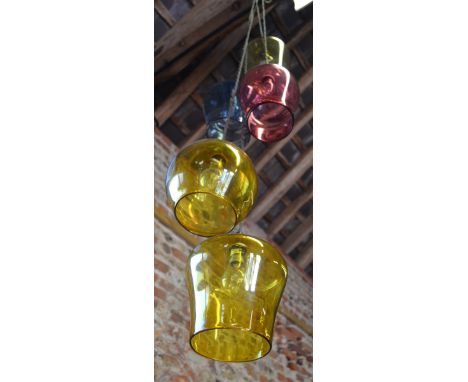 A pair of contemporary hanging cluster light fittings each having five coloured glass shades, retailed by Curiousa and Curiou