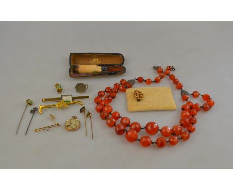 A double row faceted graduated cornelian necklace to/w cheroot holder, coin ring, various tie pins, brooch, memorial pendant 