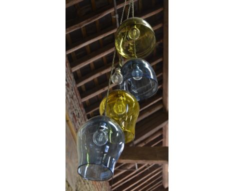 A contemporary hanging cluster light fitting having five coloured glass shades (one missing), retailed by Curiousa and Curiou
