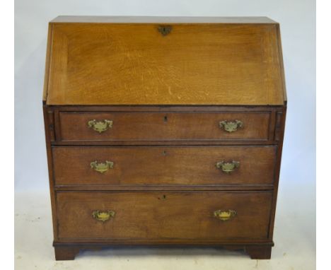 A George III oak bureau, the hinged fall enclosing a fitted interior over three long graduated drawers, on bracket feet, 106 