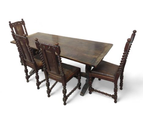A stained-oak dining table with single stretcher spanning two top-lining legs, alongside four oak chairs with drop-in leather