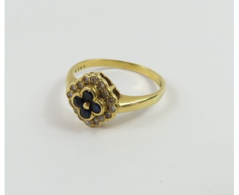 An 18ct gold unusual sapphire and diamond ring, of quatrefoil design, finger size Q+, 3.57g gross