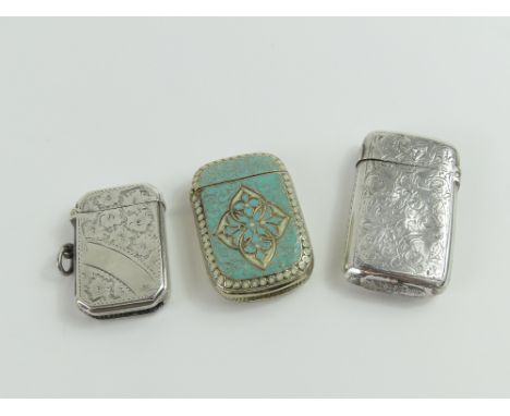 A collection of three silver vesta cases of varying designs and shapes; two with floral patterns and one with blue and white 