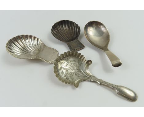 Three Georgian silver caddy spoons and one more unmarked. Three of the bowls are shell shaped and the other smooth. Of differ