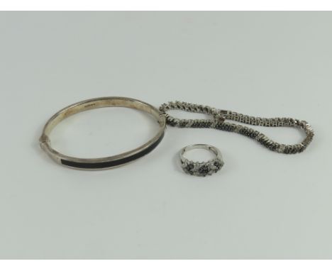 A black and white diamond ring, the stones claw set, marked '925', finger size N 1/2; together with a black and white diamond