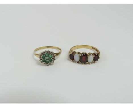 A 9ct gold garnet and white pearl five stone ring, finger size T and a 9ct gold emerald and diamond cluster ring, finger size