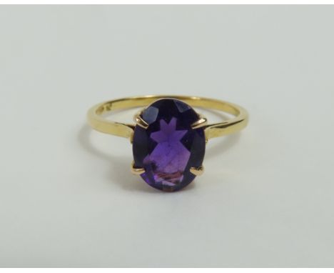 An amethyst single stone ring, the oval shaped stone in a four claw setting, marked '14k', finger size M 1/2, 2.07g gross