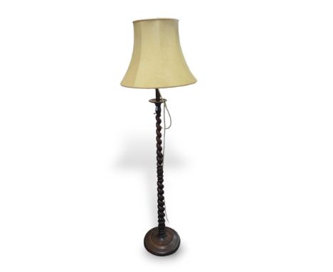 A 20th-century lamp with barley-twist post and simple bell shade. 180cm tall without shade