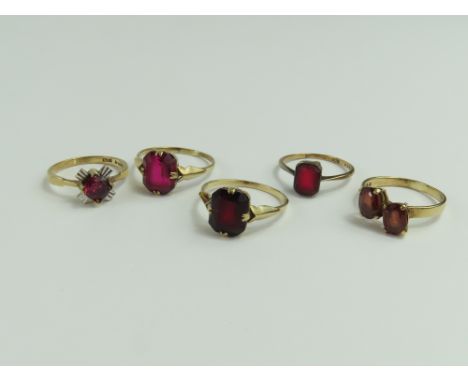 A 9ct gold two stone garnet ring, a 9ct gold ring set with a synthetic ruby, and three rings set with red paste stones and ma