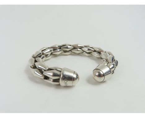 Fope - a white metal torque bangle, made up of convex diamond shaped links, with solid rounded ends, marked '925', 6cm intern