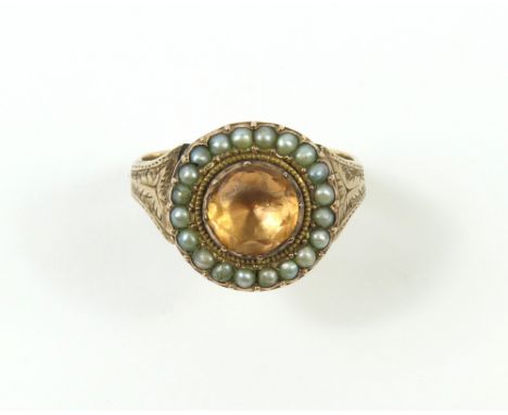 A Georgian foil backed peach coloured stone and split pearl cluster ring, with closed back setting and decoratively engraved 