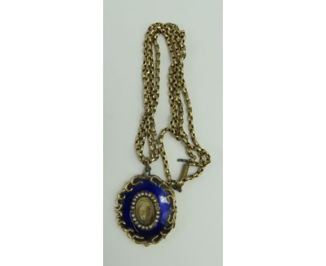 A 19th century mourning pendant, the central panel with hair and wire work under glass, with a row of split pearls around, an