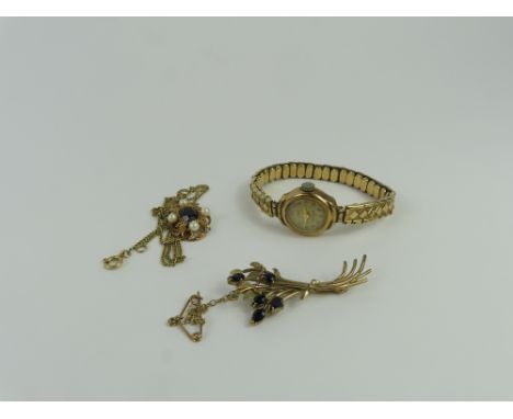 A ladies 9ct gold Strad watch face on later expanding bracelet, a 9ct gold brooch set with sapphires, a 9ct gold garnet and p
