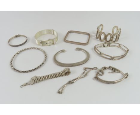 A silver flattened torque style bangle, a silver ID bracelet with feature hallmark, a silver christening bangle and various o