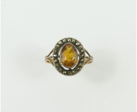A synthetic orange sapphire and marcasite cluster ring, finger size H1/2, acid tests as approximately 14-15ct gold, 2.2g gros