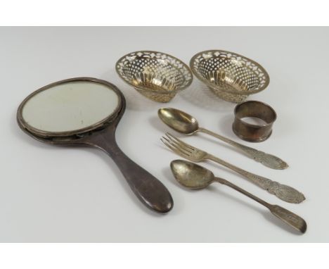A small collection of Victorian and later silver items, including a hand-held mirror, a small fork, a napkin ring, two teaspo
