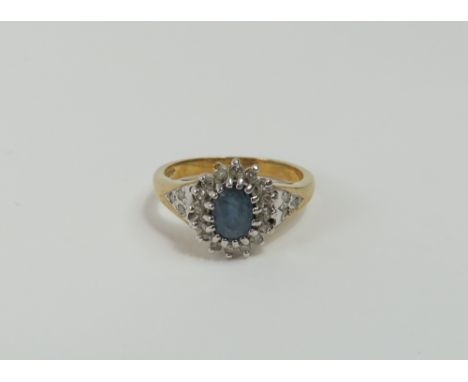 A 9ct gold sapphire and diamond cluster ring, with diamonds set to the shoulders, finger size K, 2.86g gross