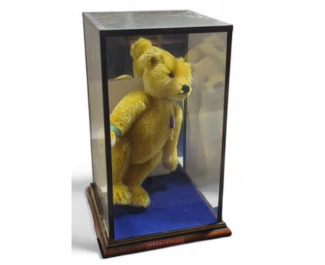 A Steiff teddy bear, "Teddybär Help for Heroes", numbered 663598 and of 2010. With rubber wrist band and medal. Within custom