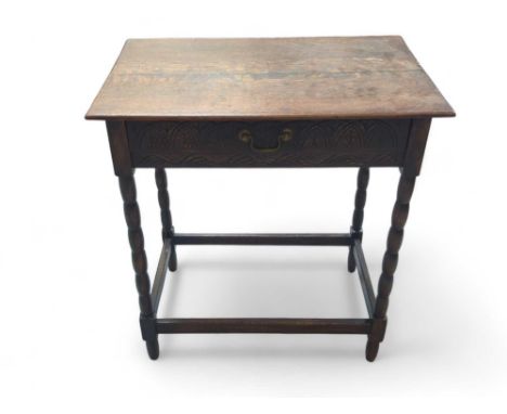 A reproduction stained-oak side drawer upon bobbin legs and with surrounding stretcher. Reminiscent of 18th-century style, wi