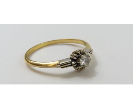 An 18ct gold diamond solitaire ring, with a textured mount and shoulders, finger size S, 2.62g gross