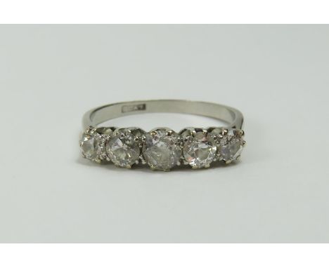 An early 20th century diamond five stone ring, the old cut stones graduated and in claw settings, diamond total weight approx
