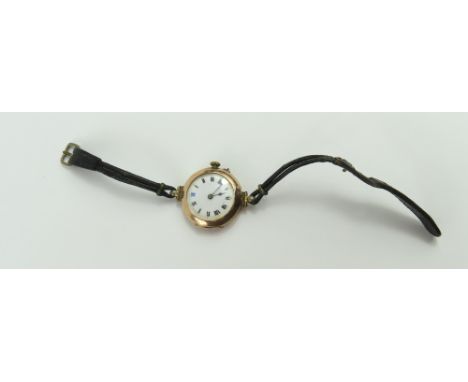An unnamed 9ct gold watch face, the white enamel dial with black and blue Roman numerals and blue steeled hands, on a cord st
