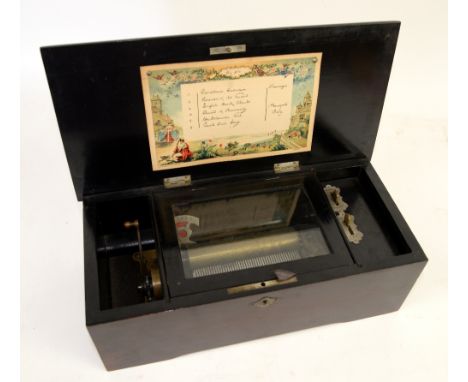 Early 20th century faux rosewood cased six aire music box, 35cm wide..    Case: gilt cartouche to cover with wear; knocks and