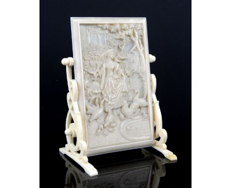 A European ivory table screen carved with a standing girl beside farmyard fowl and other birds, 10.5 x 6.5 cmProvenance: The 