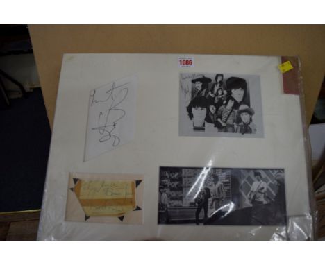 Autographs: a Rolling Stones mounted display, comprising: a Bill Wyman signed photographic print; a Charlie Watts signed card