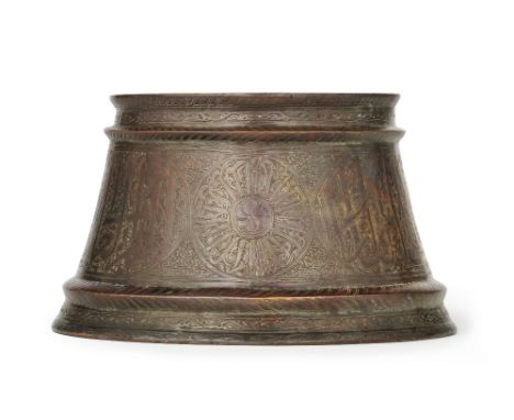 A Mamluk silver-inlaid bronze candlestick base Egypt or Syria, 14th Centuryof flaring truncated conical form with raised rib 