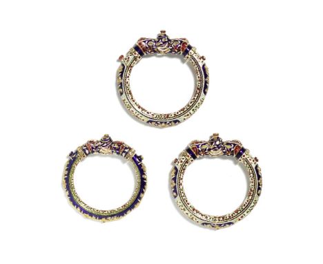 Three gem-set enamelled gold bangles (kada) North India, 20th Centurya pair and a further bangle, each of circular form, the 