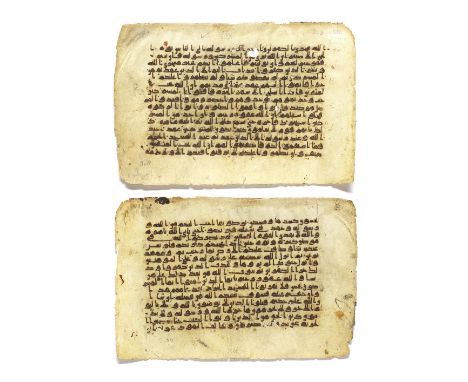 Two consecutive leaves from a manuscript of the Qur'an written in kufic script on vellum Near East or North Africa, 9th-10th 