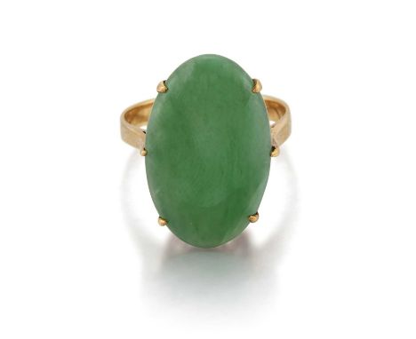 A JADE RING an oval jade in a claw setting and above a scroll gallery. Unmarked, ring size J1/2, 3.5 gramsShank later. The ja
