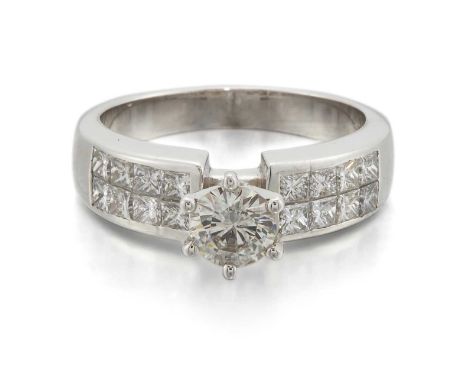 A DIAMOND RING a round brilliant-cut diamond to shoulders channel-set with two rows of princess-cut diamonds. Estimated princ