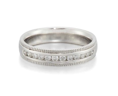 A PLATINUM DIAMOND HALF HOOP RING channel-set with round brilliant-cut diamonds between milgrain borders. Estimated total dia