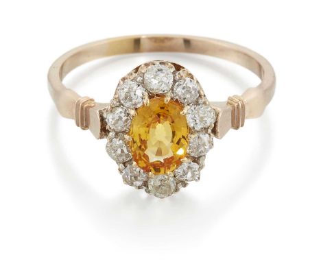 A LATE 19TH CENTURY YELLOW SAPPHIRE AND DIAMOND CLUSTER RING an oval-cut yellow sapphire within a border of old-cut diamonds,