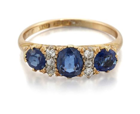 A LATE 19TH CENTURY SAPPHIRE AND DIAMOND RING three graduated cushion-cut sapphires spaced by groups of three old-cut diamond