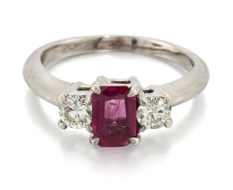 A RUBY AND DIAMOND THREE STONE RING an octagonal-cut ruby spaced by round brilliant-cut diamonds. Estimated total diamond wei