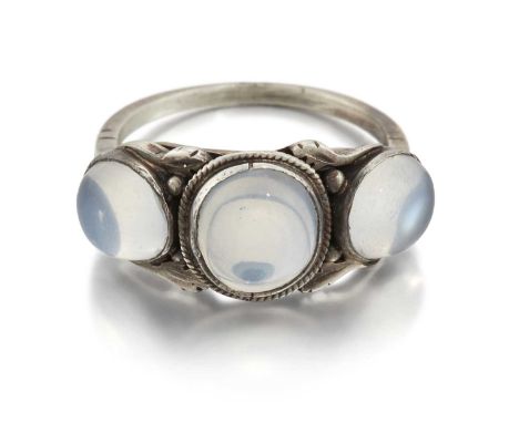 AN ARTS AND CRAFTS MOONSTONE THREE STONE RING graduated oval moonstone within a folate frame. Unmarked, ring size M1/2, 3.6 g
