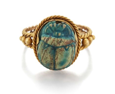 AN EGYPTIAN FAÏENCE SCARAB RING the turquoise faïence scarab engraved with hieroglyphics, within a rope frame and forked rope