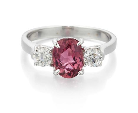 AN 18 CARAT WHITE GOLD PINK TOURMALINE AND DIAMOND THREE STONE RING an oval-cut pink tourmaline spaced by round brilliant-cut