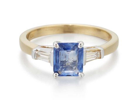 A SAPPHIRE AND DIAMOND THREE STONE RING an octagonal step-cut sapphire spaced by baguette-cut diamonds. Estimated total diamo