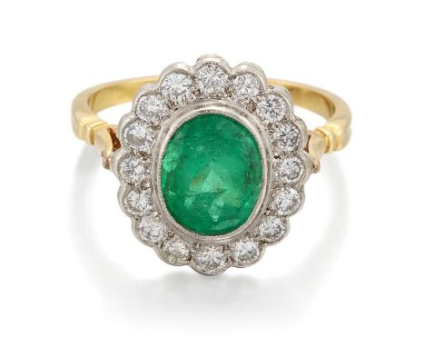 AN EMERALD AND DIAMOND CLUSTER RING an oval-cut emerald within a milgrain border of round brilliant-cut diamonds. Estimated t