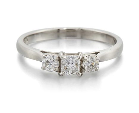 A PLATINUM DIAMOND THREE STONE RING a princess-cut diamond spaced by round brilliant-cut diamonds. Estimated total diamond we