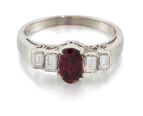 A RUBY AND DIAMOND RING an oval-cut ruby spaced by pairs of baguette-cut diamonds, above a scroll gallery. Total diamond weig